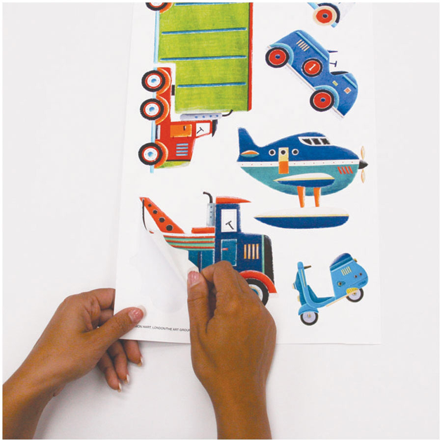 RoomMates wall decal Transportation, hands peeling a seaplane motif off the backing sheet, usage example
