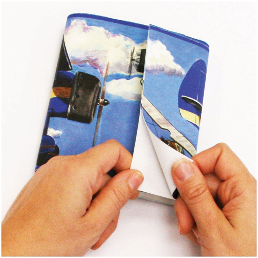 RoomMates border Vintage Planes, hands folding the border strip with an aeroplane motif, usage example