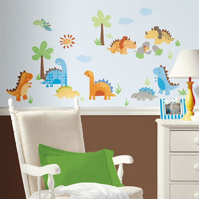 RoomMates wall decal Babysaurus, colourful dinosaur motifs with palm trees and a sun on a light blue children's room wall behind a rocking chair