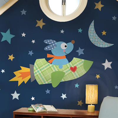RoomMates wall decal Rocketdog, dog in a green plaid rocket ship with a heart motif among stars and a moon on a dark blue children's room wall above a chest of drawers