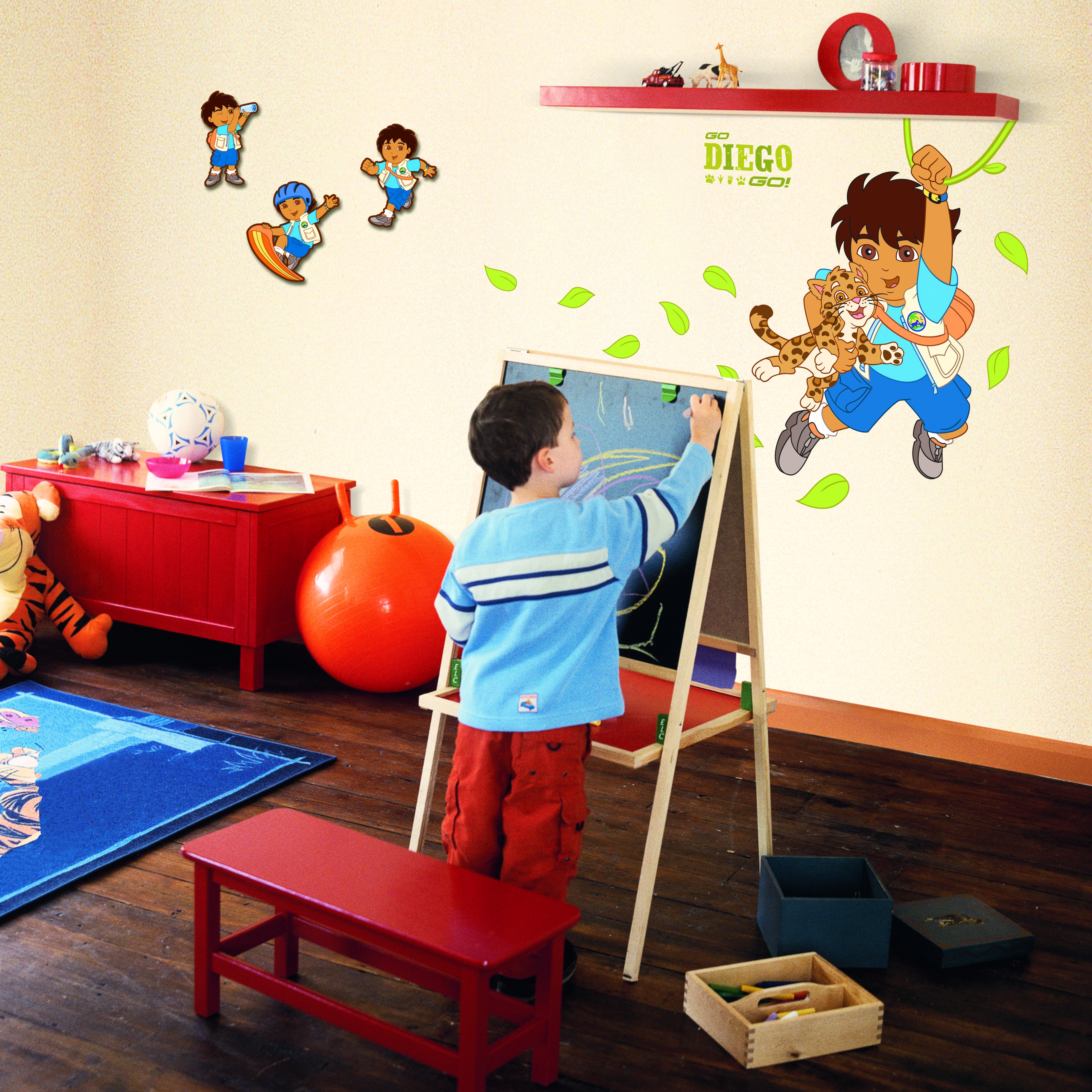 decofun wall decoration Go Diego Go lifestyle photo, Diego with a baby jaguar on the wall above a red desk with a child drawing