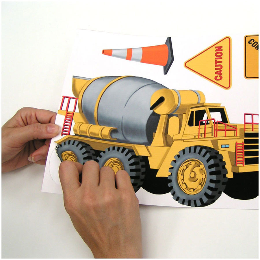RoomMates wall decal Under Construction, hands peeling a cement mixer motif off the backing sheet, usage example