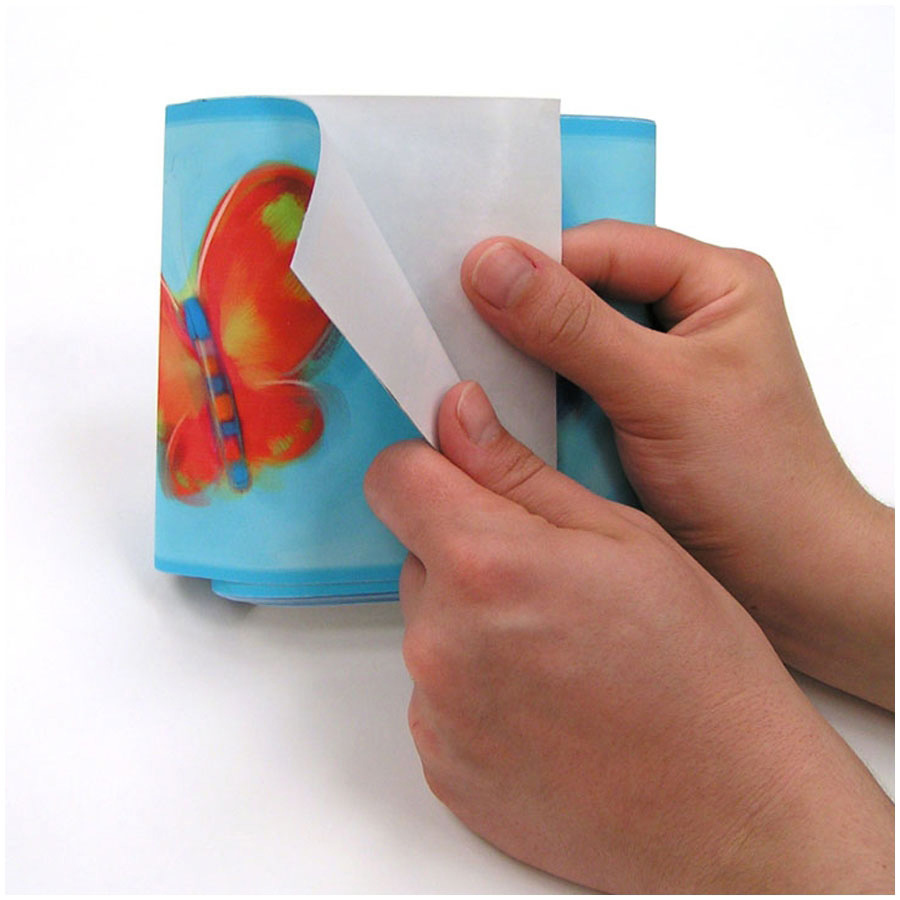 RoomMates border Jelly Bugs, hands peeling the blue border strip with a butterfly motif off the backing paper, usage example