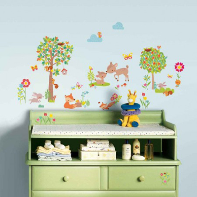 RoomMates wall decal Woodland Animals, woodland animals such as a deer, fox and squirrel with trees and flowers on a light blue children's room wall above a changing table