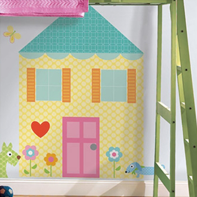 RoomMates wall decal Play House, yellow dollhouse motif with a pink door, flowers and dog motifs on a white children's room wall next to a ladder