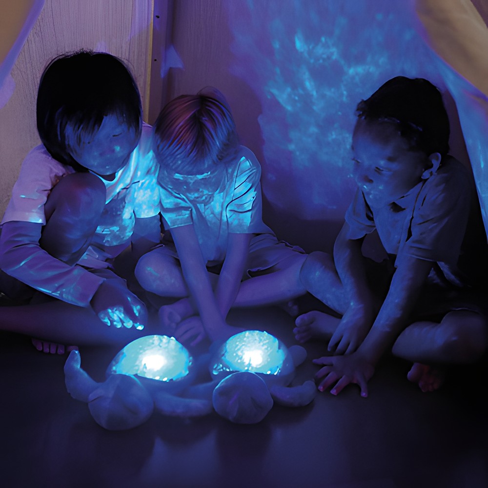 Cloud b sleep aid Tranquil Turtle Ocean, lifestyle photo with two children and glowing plush turtles in a tent