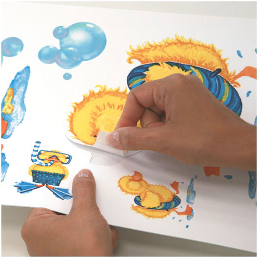 RoomMates wall decal Bubble Bath, hands peeling a duck motif off the backing sheet, usage example