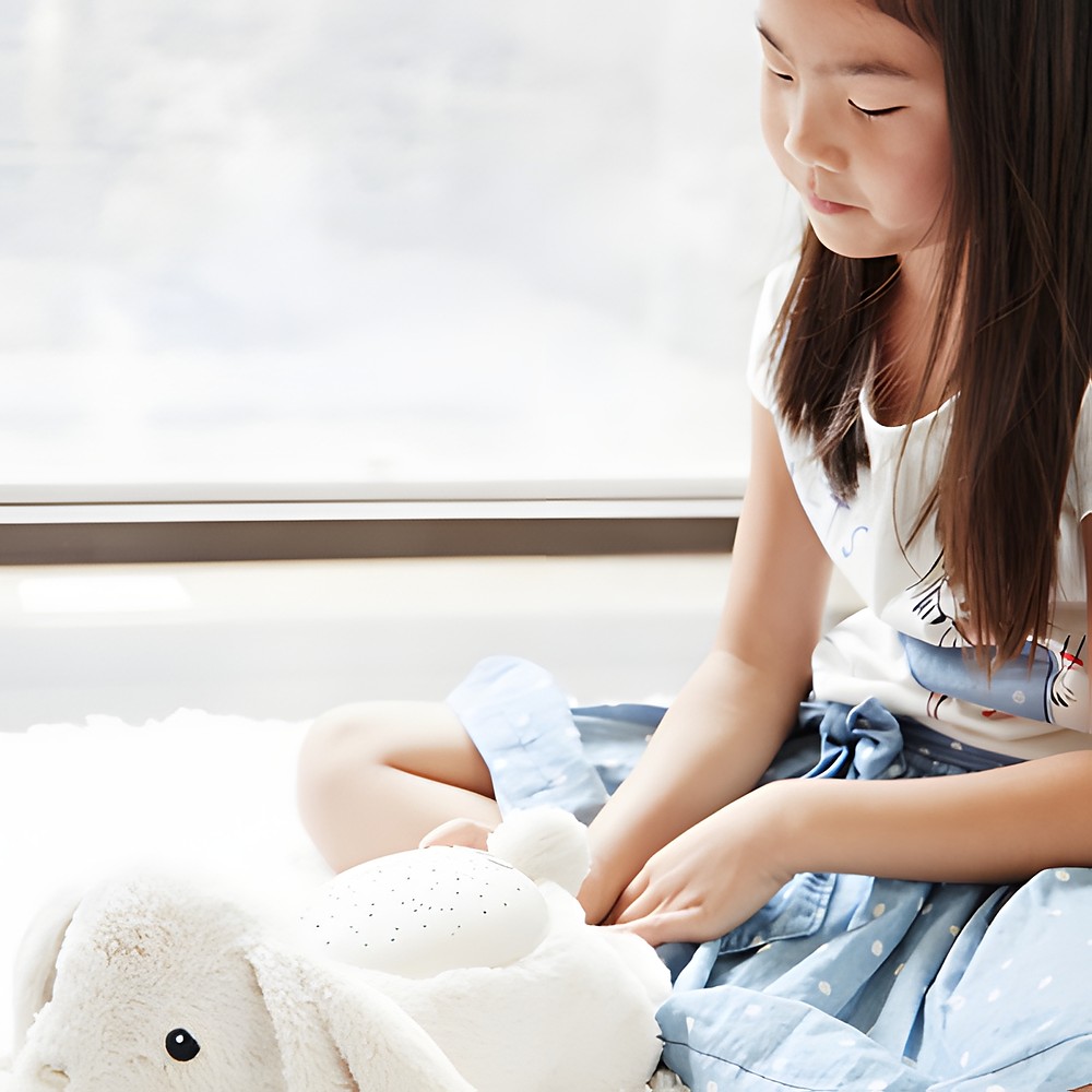 Cloud b sleep aid Twilight Buddies rabbit, lifestyle photo with girl holding the plush toy