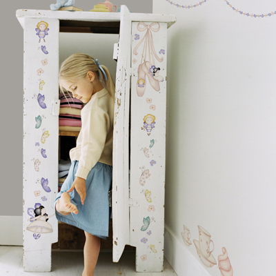 graham & brown 3D wall decoration Heirloom, white wardrobe decorated with fairy and butterfly stickers, girl in front of it